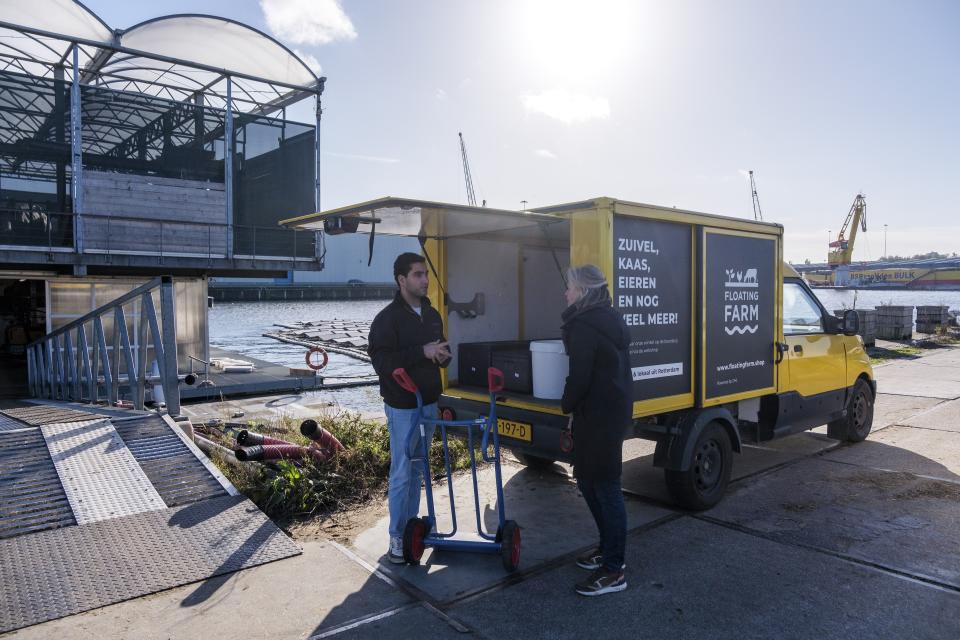 Employees work at the Floating Farm on Nov. 7 2023, in Rotterdam, Netherlands. The farm’s owners say the extreme weather spurred by climate change — heavy rainfall and flooding of cities and farmland — makes the farm's approach climate-adaptive to feed those cities. (AP Photo/Patrick Post)