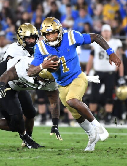 Pasadena, California November 13, 2021: UCLA quarterback Dorian Thompson-Robinson avoids.