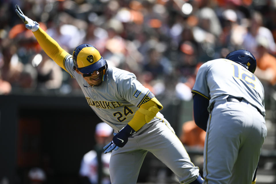 Milwaukee Brewers' William Contreras, left, celebrates after his home run with Rhys Hoskins (12) during the first inning of a baseball game against the Baltimore Orioles, Sunday, April 14, 2024, in Baltimore. (AP Photo/Nick Wass)
