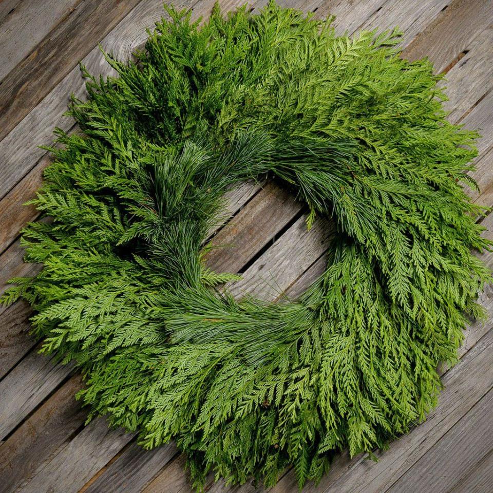 <p>lynchcreekwreaths.com</p><p><strong>$49.95</strong></p><p>A classic cedar wreath can always be punched up with a pretty ribbon in any color. </p>