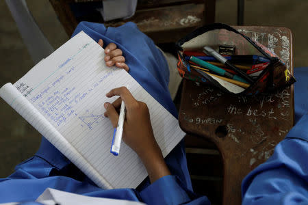 A student takes notes during class at the Islamabad College for girls in Islamabad, Pakistan, October 13, 2017. REUTERS/Caren Firouz