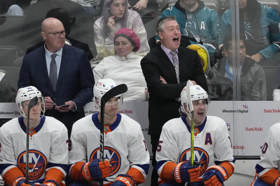 New York Islanders coach Patrick Roy, standing at right, yells to players during the third period of the team's NHL hockey game against the San Jose Sharks in San Jose, Calif., Thursday, March 7, 2024. (AP Photo/Jeff Chiu)