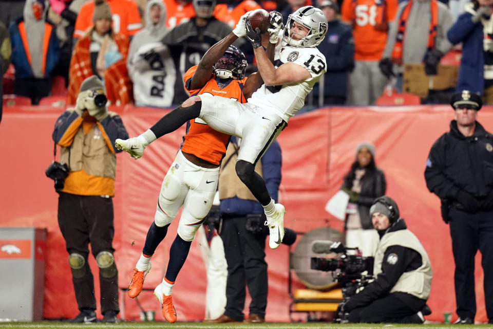 Oakland Raiders wide receiver Hunter Renfrow (13) hauls in a pass as Denver Broncos cornerback Isaac Yiadom defends during the second half of an NFL football game Sunday, Dec. 29, 2019, in Denver. (AP Photo/Jack Dempsey)