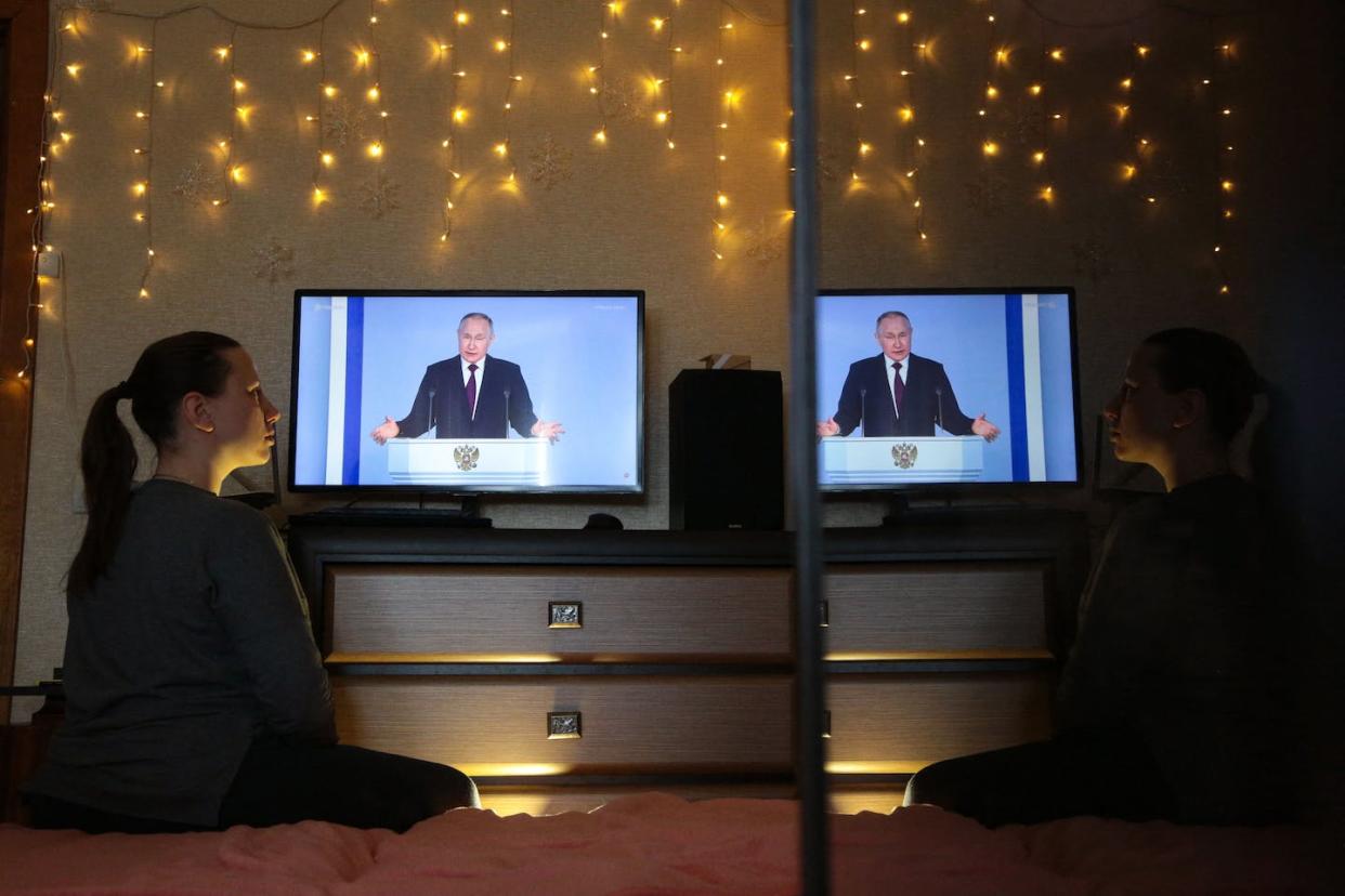 A woman in Crimea watches a TV broadcast of Russian President Vladimir Putin's speech on Feb. 21, 2023. <a href="https://media.gettyimages.com/id/1247345395/photo/crimea-russia-ukraine-conflict-politics.jpg?s=1024x1024&w=gi&k=20&c=UqQnoifQCfSbPhe_nmZuOHXBei9wh71hD85x_jRii8M=" rel="nofollow noopener" target="_blank" data-ylk="slk:Stringer/AFP via Getty Images;elm:context_link;itc:0;sec:content-canvas" class="link ">Stringer/AFP via Getty Images</a>