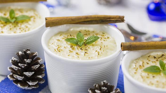 rice pudding with cinnamon, new year ornaments in blue color in new year traditions