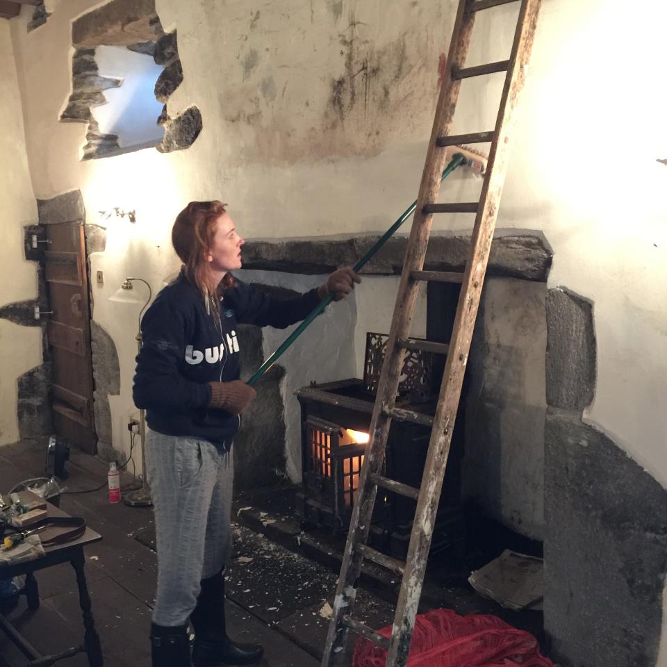 Stef Burgon, co-owner of Kilmartin Castle, is pictured working on the castle's walls during the renovation.