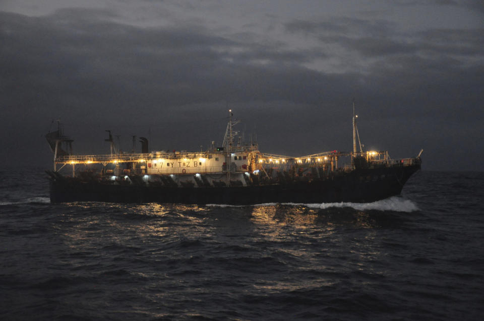 FILE - The Chinese-flagged Lu Rong Yuan Yu 609 prepares to fish for squid on the high seas near the Galapagos Islands on July 19, 2021. Fishing takes place almost exclusively at night when each ship turns on hundreds of lights as powerful than anything at a stadium to attract swarms of fast-flying squid. The concentration of lights is so intense it can be seen from space on satellite images that show the massive fleet shining as brightly as major cities hundreds of miles away on land. (AP Photo/Joshua Goodman, File)