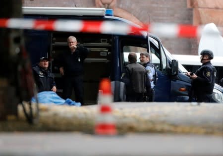 Police officers are seen at the site of a shooting in Halle