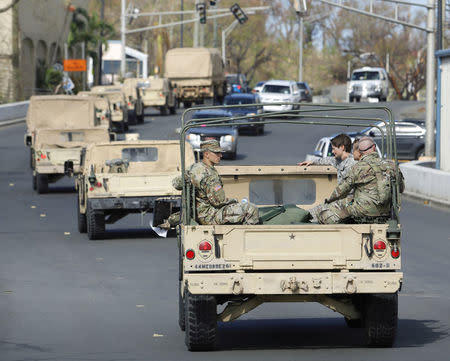 Soldiers from the 602nd Area Support Medical Company ride in a convoy to an extraction point as their unit evacuates in advance of Hurricane Maria, in Charlotte Amalie, St. Thomas, U.S. Virgin Islands September 17, 2017. REUTERS/Jonathan Drake