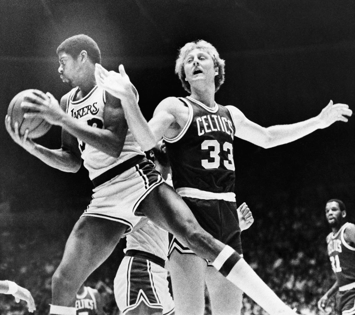Los Angeles Lakers Earvin "Magic" Johnson (32) rips a rebound from the hands of Boston Celtics Larry Bird (33) during the first half, Dec. 28, 1979 in Los Angeles. It was the first time both former NCAA stars met in combat since last year's NCAA Tournament. (AP Photo)