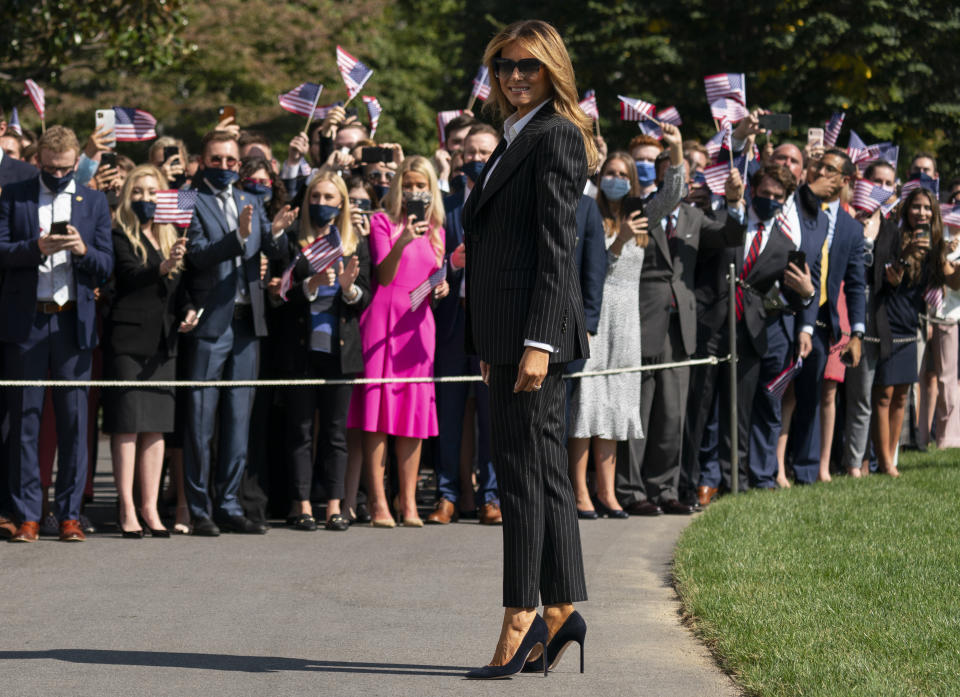 First lady Melania Trump pauses as she and President Donald Trump walk to board Marine One at the White House, Tuesday, Sept. 29, 2020, in Washington, for the short trip to Andrews Air Force Base en route to Cleveland for first debate against Democrat Joe Biden. (AP Photo/Carolyn Kaster)