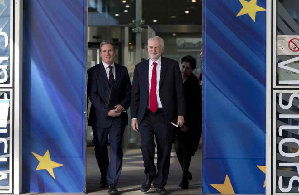 British Labour Party leader Jeremy Corbyn, right, and shadow Brexit Secretary Keir Starmar leave EU headquarters in Brussels, Thursday, Feb. 21 2019. Corbyn is in Brussels to meet European Union chief Brexit negotiator Michel Barnier. (AP Photo/Virginia Mayo)