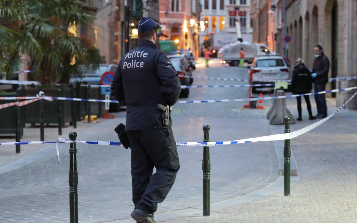 Police keep watch outside the police headquarters after a knife attack on a police officer - REUTERS