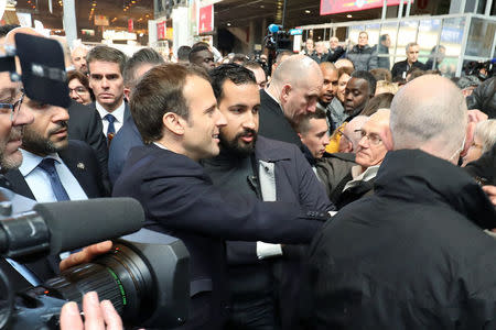 French President Emmanuel Macron, flanked by Elysee senior security officer Alexandre Benalla (R) visits the 55th International Agriculture Fair (Salon de l'Agriculture) at the Porte de Versailles exhibition center in Paris, France, February 24, 2018. Ludovic Marin/Pool via Reuters