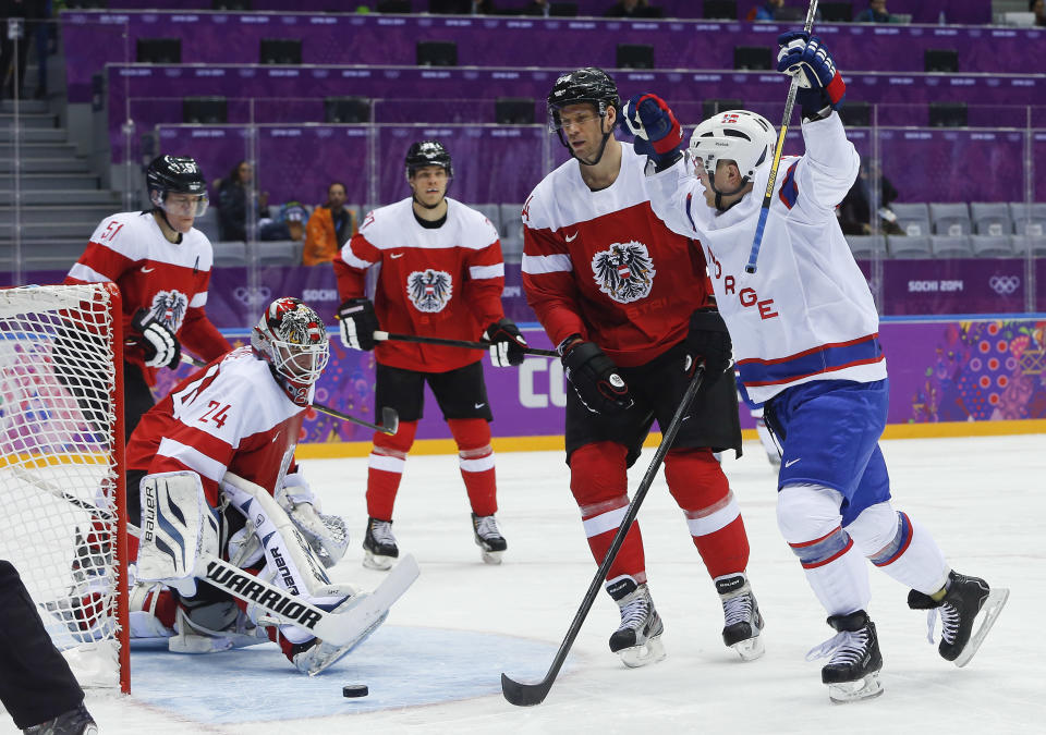 Norway forward Per-Age Skroder, right, reacts after scoring a goal against Austria in the second period of a men's ice hockey game at the 2014 Winter Olympics, Sunday, Feb. 16, 2014, in Sochi, Russia. (AP Photo/Mark Humphrey)