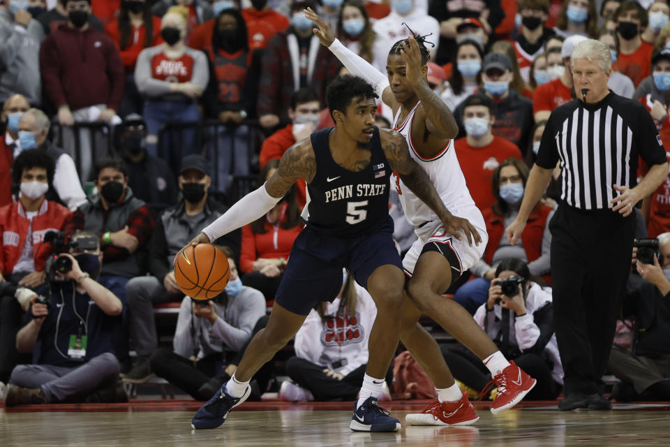 Penn State's Greg Lee, left, posts up against Ohio State's Eugene Brown during the second half of an NCAA college basketball game Sunday, Jan. 16, 2022, in Columbus, Ohio. (AP Photo/Jay LaPrete)