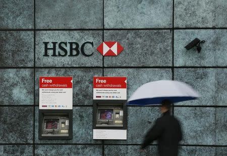 A man walks past a HSBC bank branch in the City of London November 12, 2014. REUTERS/Stefan Wermuth