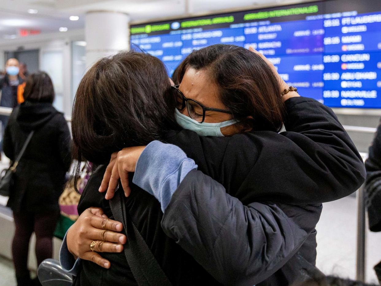 A woman hugs her relative as she arrives in Toronto, Canada, on a flight from Hong Kong shortly after Toronto Public Health received notification of Canada's first presumptive confirmed case of coronavirus, 26 January, 2020: Carlos Osorio/Reuters