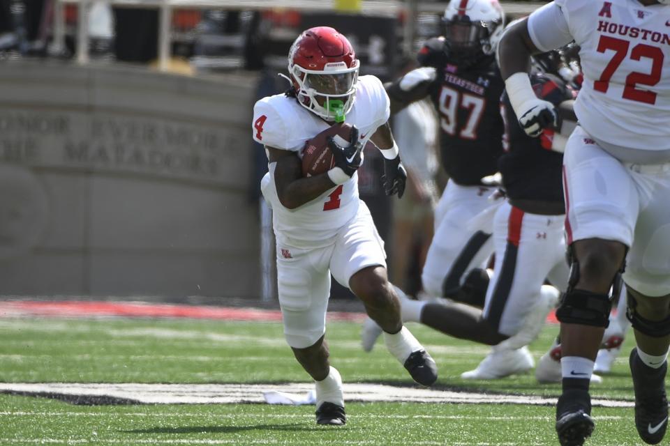 Houston running back Ta'Zhawn Henry (4) runs the ball against Texas Tech during the first half of an NCAA college football game Saturday, Sept. 10, 2022, in Lubbock, Texas. (AP Photo/Justin Rex)