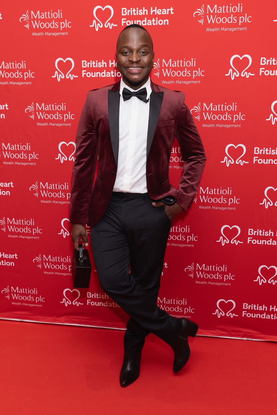 will njobvu attends the heart hero awards 2023 in a red velvety jacket