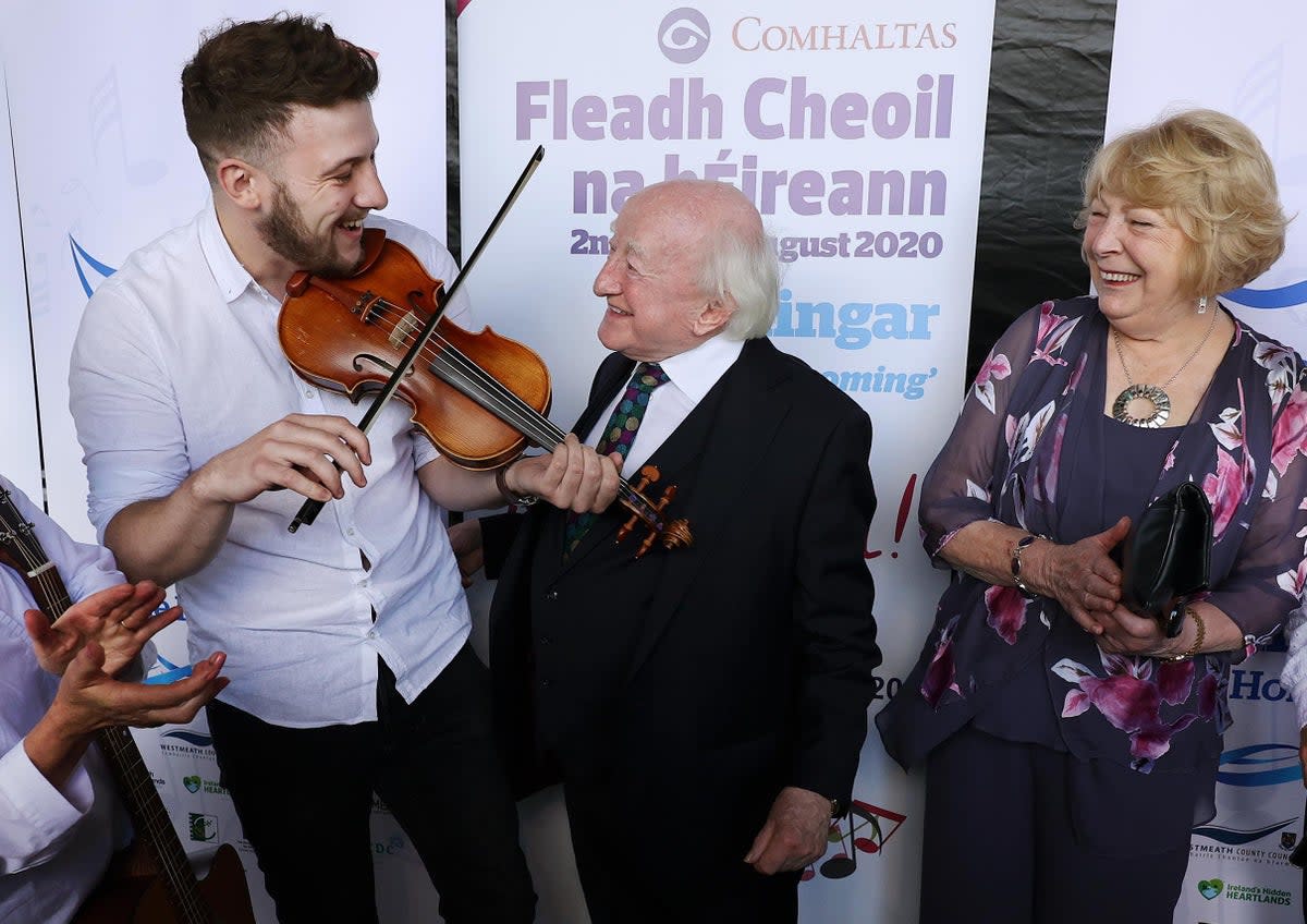 President Michael D Higgins and his wife Sabina with musician Daniel Boland (PA) (PA Wire)