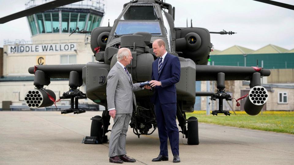 PHOTO: Britain's King Charles III officially hands over the role of Colonel-in-Chief of the Army Air Corps to Britain's Prince William in front of an Apache helicopter in Middle Wallop, England, on May 13, 2024.  (Kin Cheung/POOL/AFP via Getty Images)