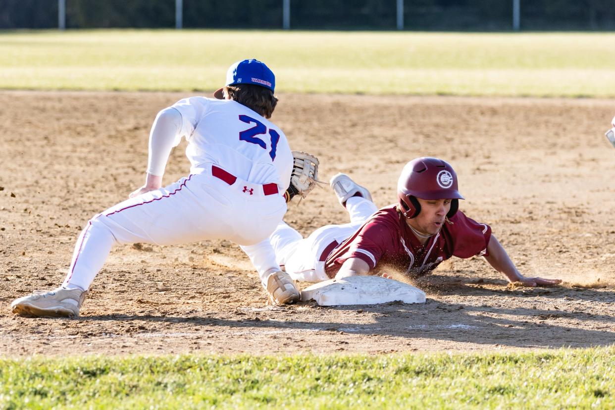 Portsmouth's Tucker Huskey dives back to first base ahead of the tag of Winnacunnet first baseman Connor Fowler during Monday's Division I baseball game in Hampton.