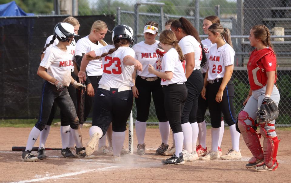 Madalyn Spencer is greeted by her Milan teammates after a home run during a 15-0 win over Grosse Ile on Monday, May 13, 2024.