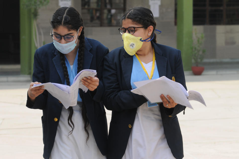 Students wear face mask to protect themselves from infection, in wake of the coronavirus (COVID-19) outbreak in Jalandhar.