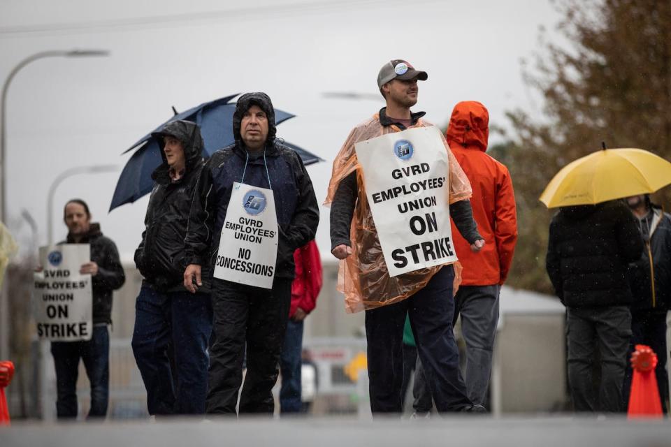 Workers with the Greater Vancouver Regional District Employees' Union (GVRDEU) are pictured on strike at the Annacis Island wastewater treatment plant in Delta, British Columbia on Monday, October 16, 2023. 