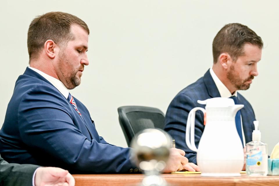 Parker Surbrook, left, takes notes while sitting with his attorney Patrick O'Keefe during Surbrook's trial on Friday, Aug. 4, 2023, at the 30th Circuit Court Annex in Lansing.