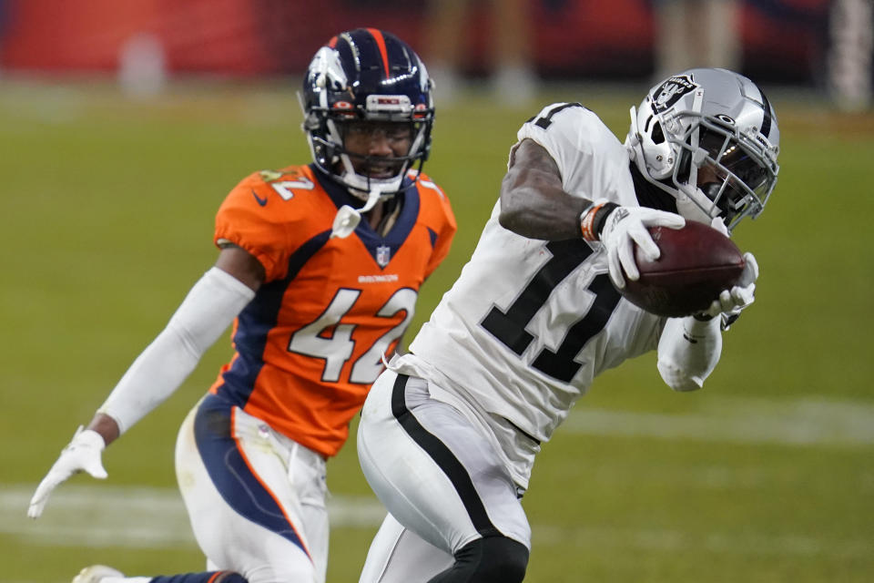 Las Vegas Raiders wide receiver Henry Ruggs III (11) makes a catch against Denver Broncos cornerback Parnell Motley during the second half of an NFL football game, Sunday, Jan. 3, 2021, in Denver. (AP Photo/David Zalubowski)