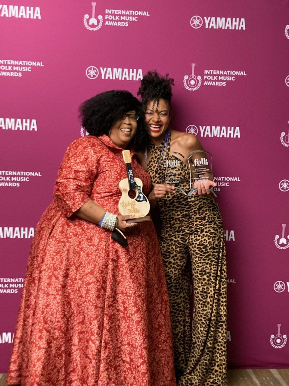 Lili Lewis, photographed with her Spirit of Folk Award, alongside two-time winner Allison Russell, at the 2022 International Folk Music Awards
