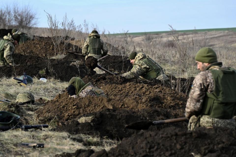 Ukrainian servicemen of the 42nd Mechanised Brigade dig trenches during a field military exercise in Donetsk Oblast on Dec. 6, 2023. (Genya Savilov/AFP via Getty Images)