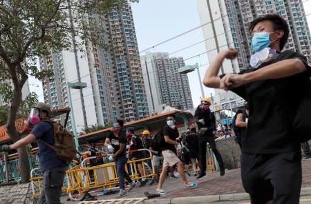 Protesters hurl objects at the police during a demonstration in support of the city-wide strike and to call for democratic reforms at Tin Shui Wai in Hong Kong