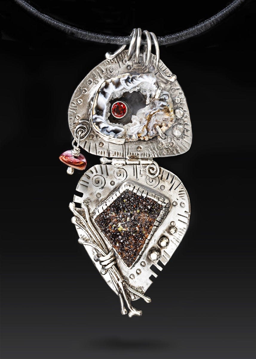 A jewelry piece called "metal smith" by artist Mary Lou Christie, from Tahlequah, Oklahoma featured in the 2019 Art on the Border show and sale.