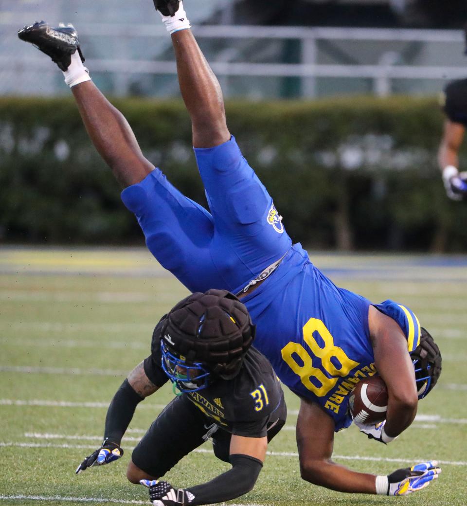 Delaware defensive back Hasson Manning Jr (31) upends tight end Elijah Sessoms during the Blue and White Spring Game at Delaware Stadium, Friday, April 19, 2024.