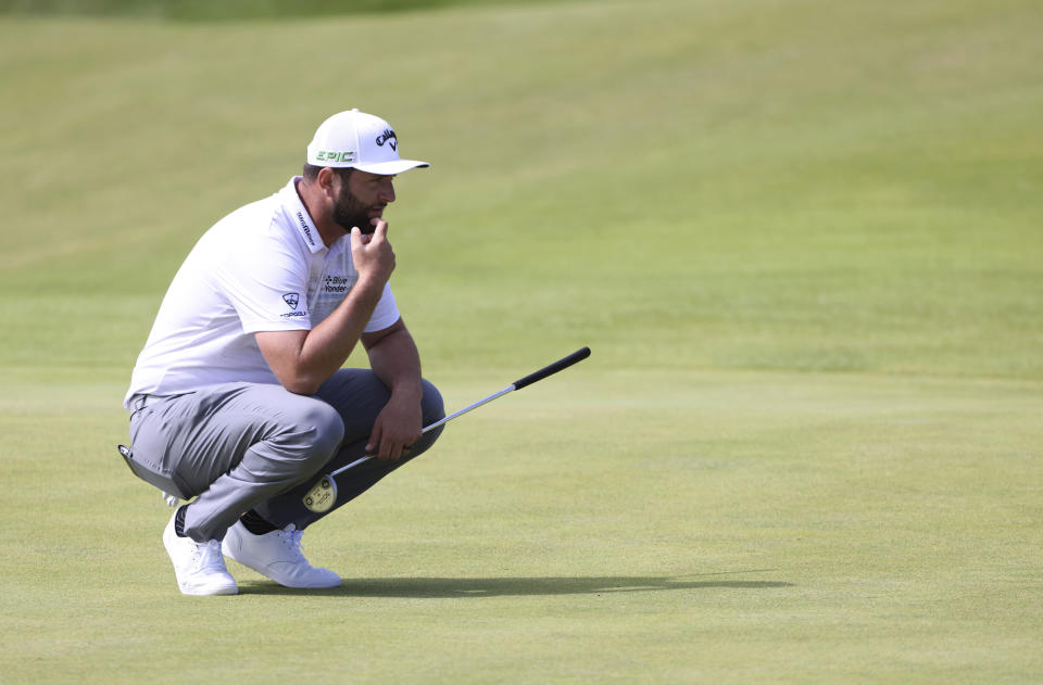 Spain's Jon Rahm looks at the line of his putt on the 3rd green during the first round British Open Golf Championship at Royal St George's golf course Sandwich, England, Thursday, July 15, 2021. (AP Photo/Ian Walton)