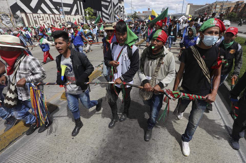 Demonstrators march during a national strike in Bogota, Colombia, Wednesday, Dec. 4, 2019. Colombia’s recent wave of demonstrations began with a massive strike on Nov. 21 that drew an estimated 250,000 people to the streets. Protests have continued in the days since but at a much smaller scale. (AP Photo/Fernando Vergara)