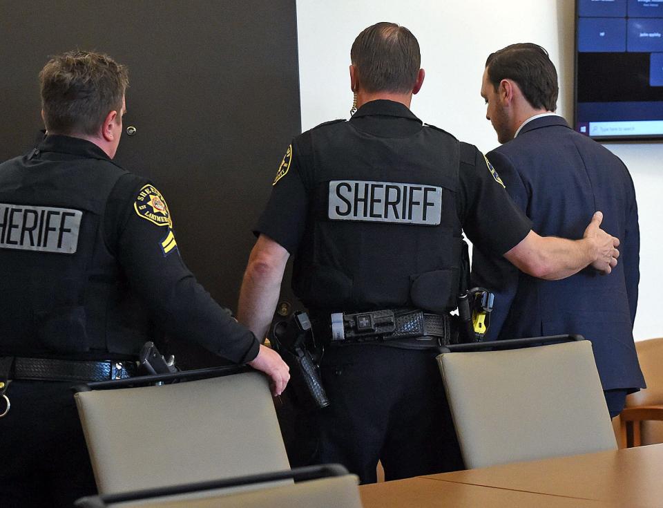 Former Loveland police officer Austin Hopp is taken into custody at the end of his sentencing hearing Thursday. Hopp was sentenced to five years in prison with three years of mandatory parole after pleading guilty to second-degree assault stemming from his 2020 arrest of Karen Garner.