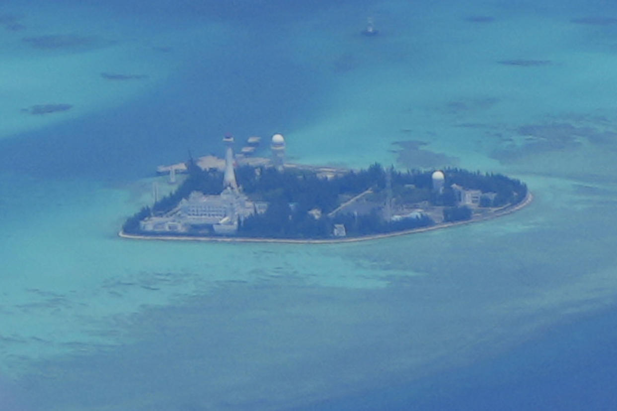 Chinese structures and buildings at the man-made island on Johnson reef at the Spratlys group of islands in the South China Sea are seen on Sunday March 20, 2022. China has fully militarized at least three of several islands it built in the disputed South China Sea, arming them with anti-ship and anti-aircraft missile systems, laser and jamming equipment and fighter jets in an increasingly aggressive move that threatens all nations operating nearby, a top U.S. military commander said Sunday. (AP Photo/Aaron Favila)