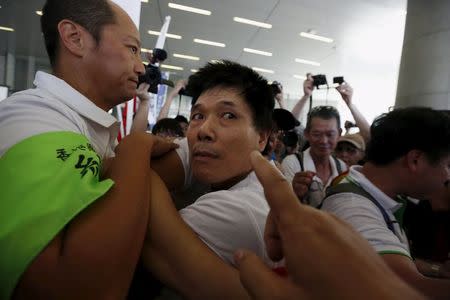 A pro-China supporter (C) is stopped by a prefect from the pro-China camp during a confrontation against pro-democracy protesters outside Legislative Council in Hong Kong, China June 17, 2015. REUTERS/Bobby Yip