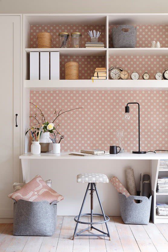 <p><strong>Vanessa says... </strong><br></p><p>'This is a built in workspace with lots of shelves and is at the end of the sitting room. My <a rel="nofollow noopener" href="https://www.vanessaarbuthnott.co.uk/pretty-maids-wall-covering-dusky-pink-winter" target="_blank" data-ylk="slk:Pretty Maids wallpaper in Dusky Pink;elm:context_link;itc:0;sec:content-canvas" class="link ">Pretty Maids wallpaper in Dusky Pink</a> makes it very cosy and soft and welcoming. The upholstered stool is yet another eBay find...and we have covered it in Pretty maids in Dove and Winter 100% Linen.'</p>