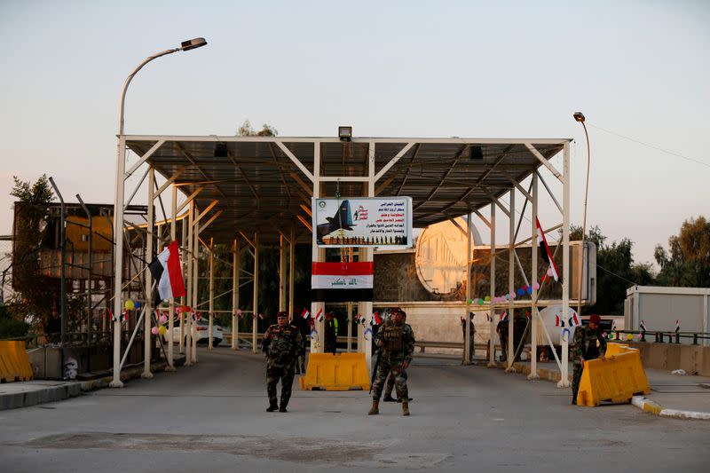 FILE PHOTO: Iraqi security forces gather at a checkpoint into the Green Zone in Baghdad