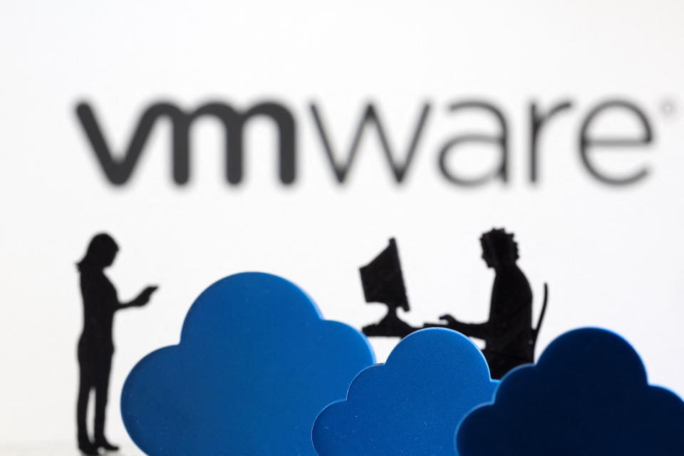 3D printed clouds and figurines are seen in front of the VMware cloud service logo in this illustration taken February 8, 2022. REUTERS/Dado Ruvic/Illustration