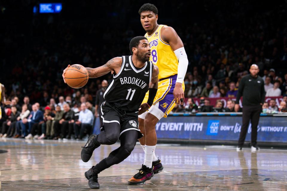 Brooklyn Nets guard Kyrie Irving (11) drives past Los Angeles Lakers forward Rui Hachimura (28) during the first half of an NBA basketball game Monday, Jan. 30, 2023, in New York. (AP Photo/Corey Sipkin)