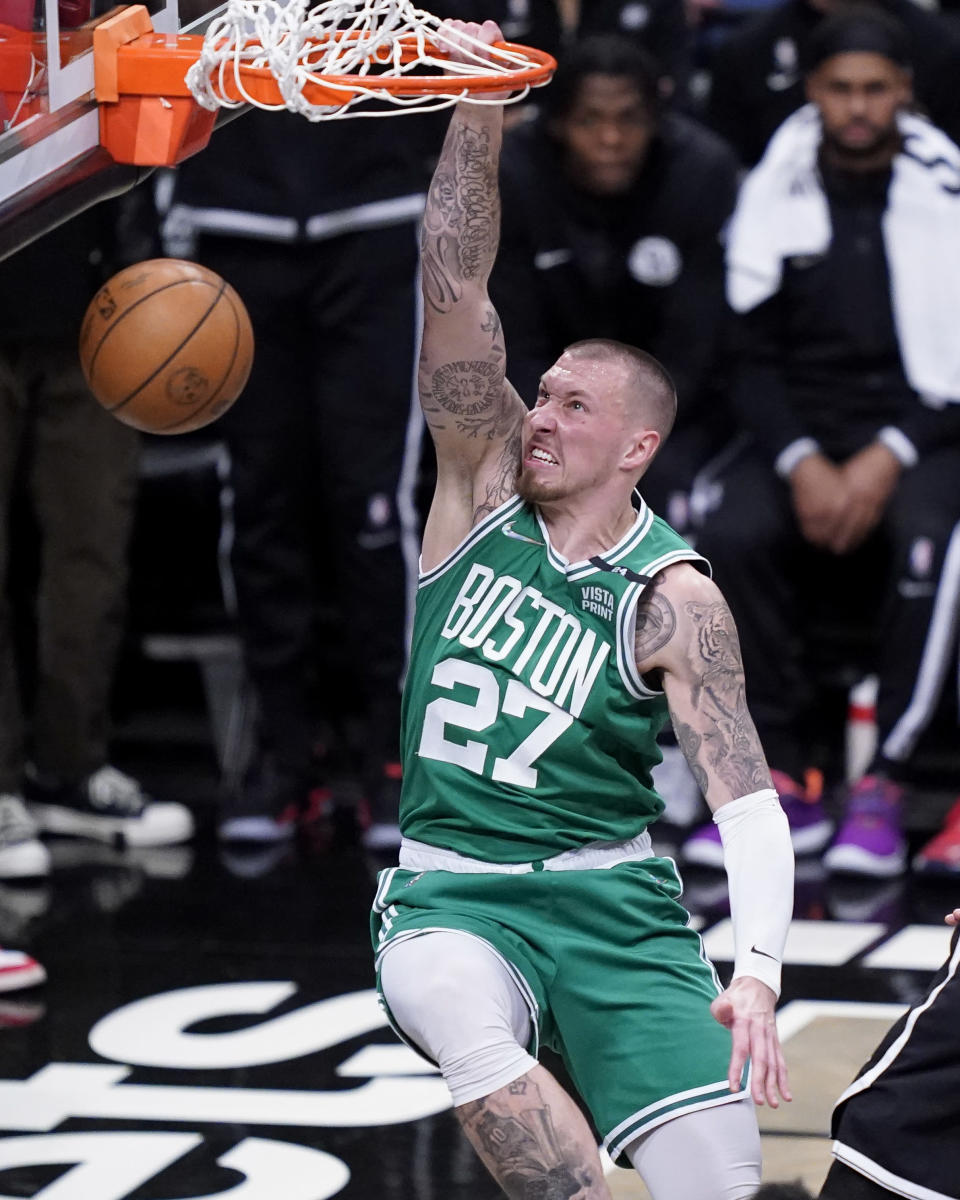 Boston Celtics center Daniel Theis (27) dunks during the first half of Game 3 of an NBA basketball first-round playoff series against the Brooklyn Nets, Saturday, April 23, 2022, in New York. (AP Photo/John Minchillo)