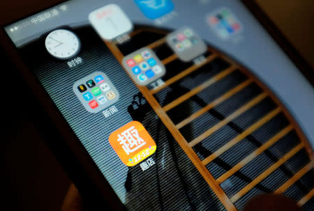 The Qudian app logo is seen on a smartphone in an illustration photo taken in Beijing, China December 1, 2017. REUTERS/Jason Lee/Illustration