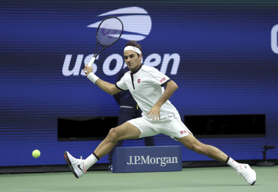 FILE - In this Aug. 28, 2019, file photo, Roger Federer, of Switzerland, returns a shot to Damir Dzumhur, of Bosnia, during the second round of the US Open tennis championships in New York. Federer will be competing in the Australian Open tennis tournament beginning Monday, Jan. 20, 2020. (AP Photo/Eduardo Munoz Alvarez, File)