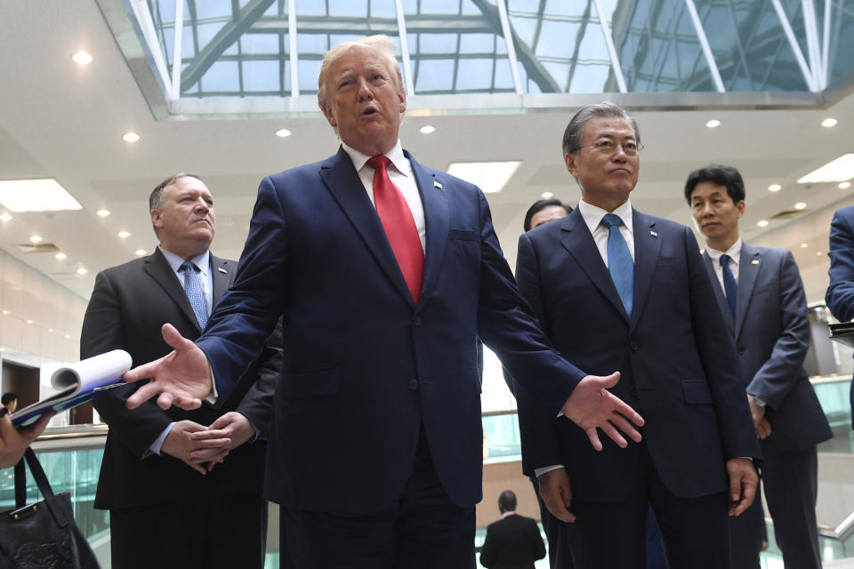 President Donald Trump talks to the media with South Korean President Moon Jae-in, right, and Sec. of State Mike Pompeo, rear left, at the border village of Panmunjom in the Demilitarized Zone, South Korea, Sunday, June 30, 2019 after he met with North Korean leader Kim Jong Un. (AP Photo/Susan Walsh)